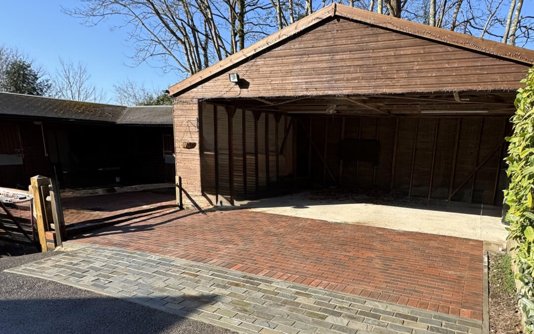 Professional driveway paving with red brick blocks and charcoal border edging